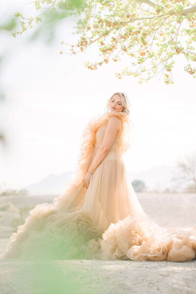 fallback shared on Invalid Date | A beautiful puffy peach gown takes over the photo as a blonde young lady poses under a t...