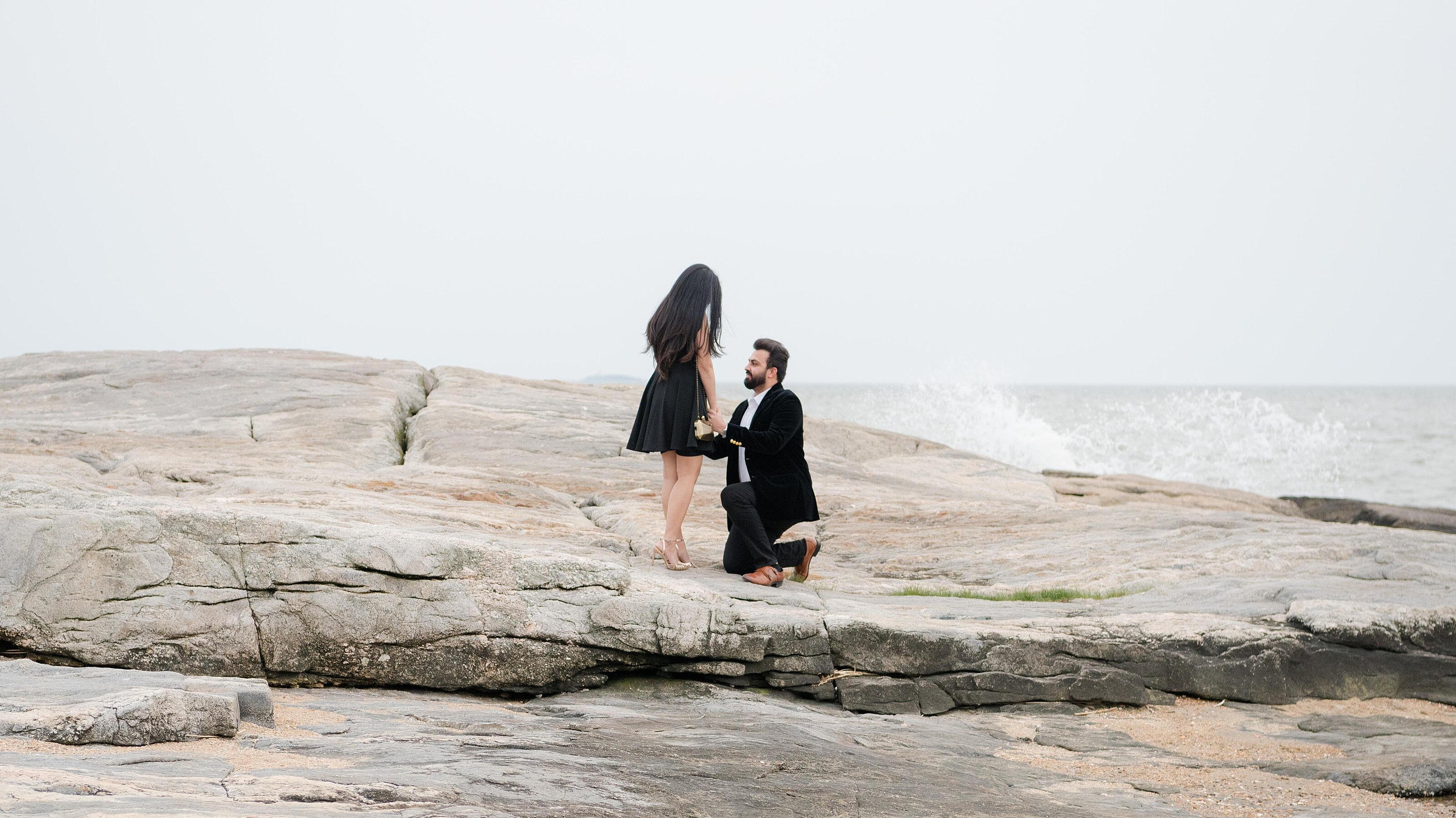 1_man-proposes-out-on-a-rock-at-the-beach
