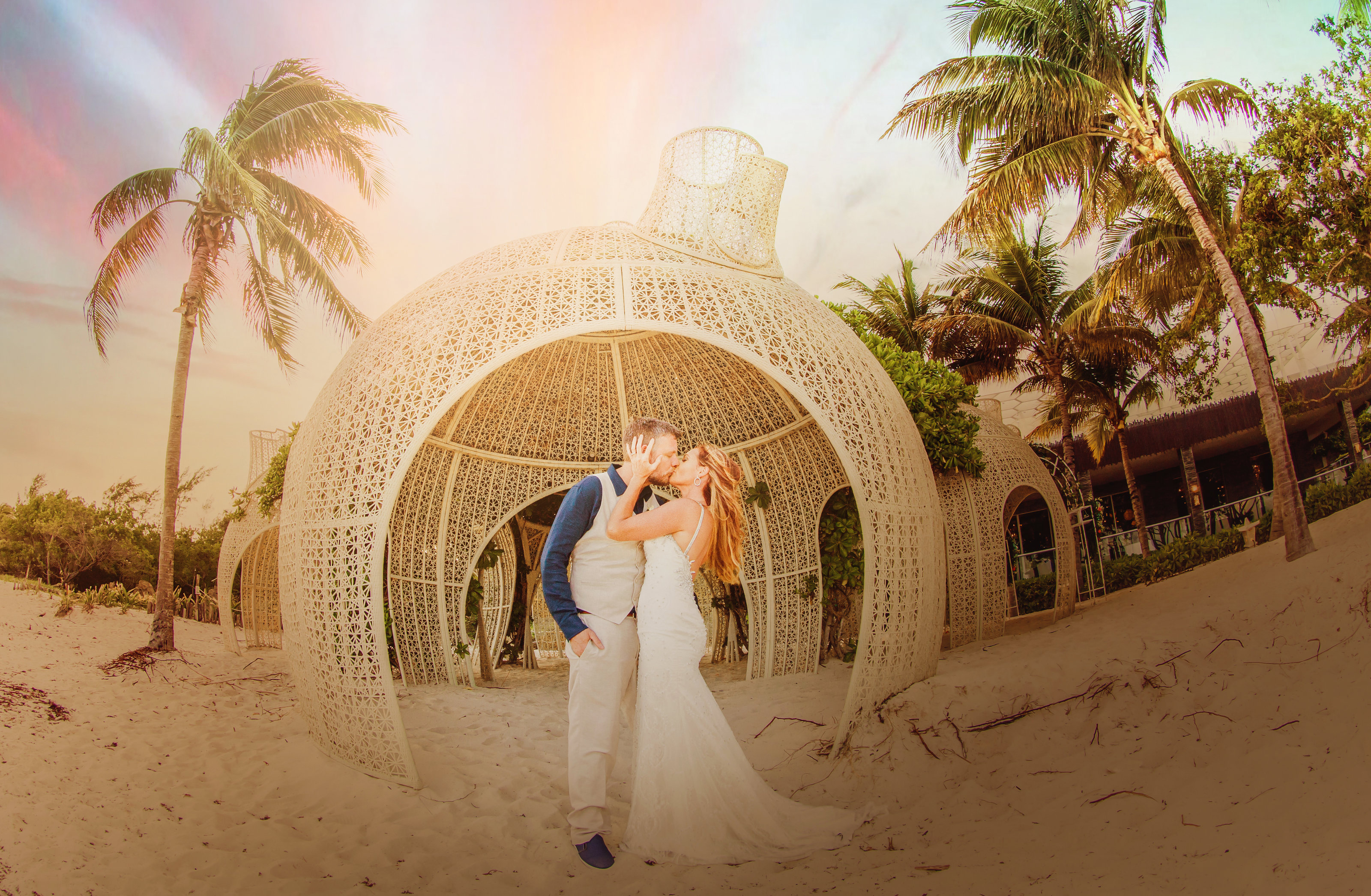 couple kissing on beach in cancun beach wedding