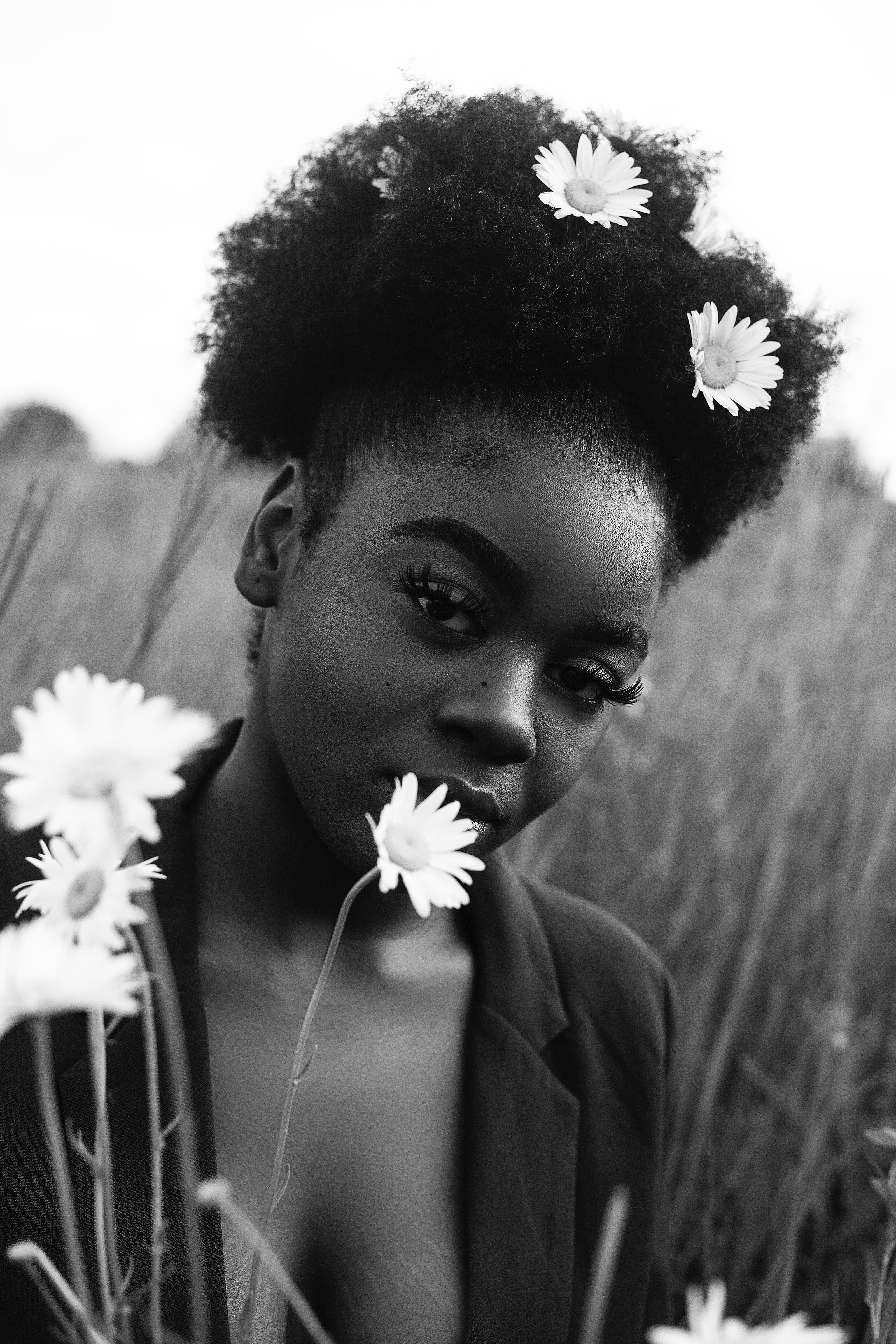 grayscale-photo-of-woman-with-daisy-on-ear-2951142