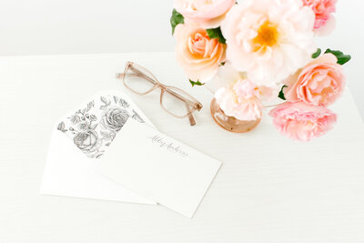 Notecard + Roses + glasses on desk
