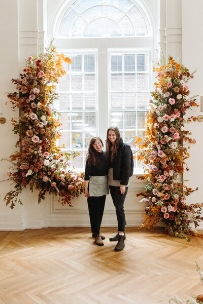 Mary Love and Mackenzie of Rosemary and Finch wedding floral designers, florists, in Nashville, TN. Specialize in large scale weddings, installation, travel weddings. Broken arch floating arch fall wedding ceremony flowers in copper, pink, burgundy, mauve, and sage.
