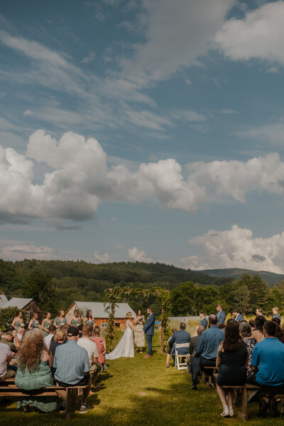 wedding ceremony at farm house flowers in vermont