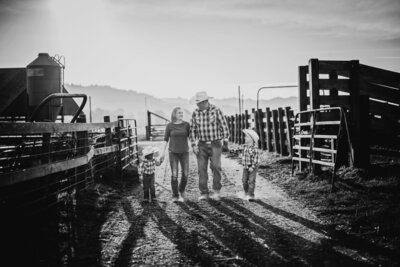 A Humboldt County ranching family walks side by side in their ranch corral.
