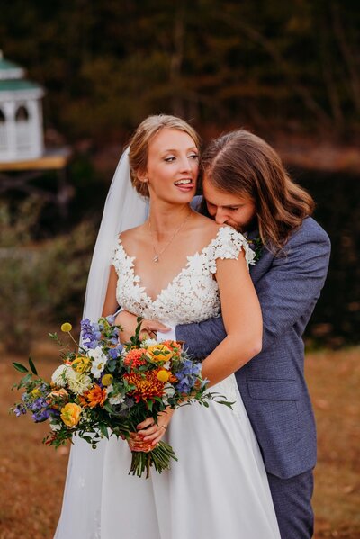 photo of a bride sticking her tongue out at her groom