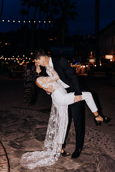 Destination wedding photographer captures Catalina Island elopement couple embracing in a dip at night