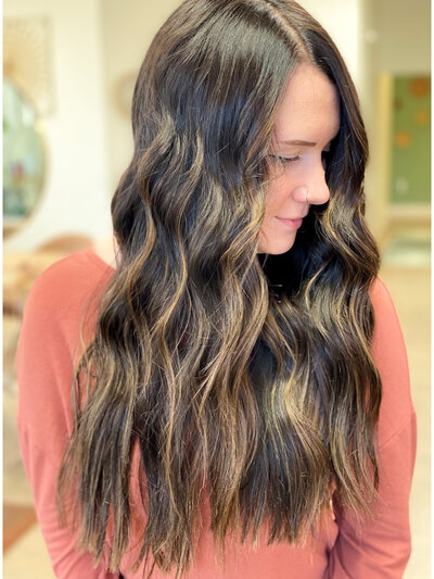 Woman smiling and touching her hair