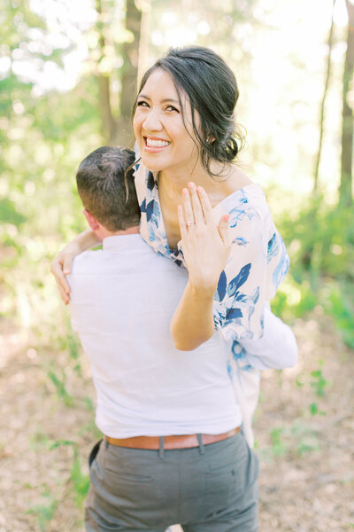 Connor lifts up Kim and twirls her around as she smiles and shows off her engagement ring to the camera in excitement