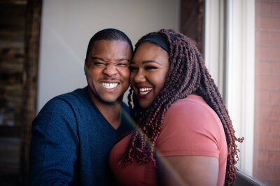 Michael T Davis, a wedding photographer in Austin, poses with his wife, looking into the camera with big smiles