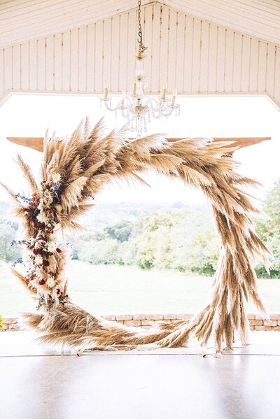 Pampa grass formed into round arbor for ceremony, boho vibes