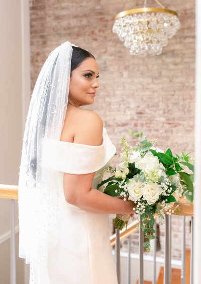 Bride posing for bridal portraits at the 718 Venue in Fredericksburg, Virginia. Captured by Bethany Aubre Photography.