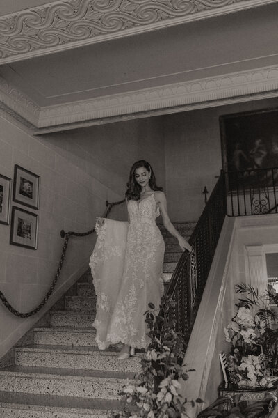 The mansion at woodward park wedding. Bride walks down rose covered staircase
