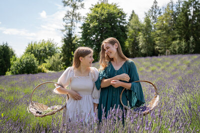 two sisters are laughing together in a lavender field north of Seattle