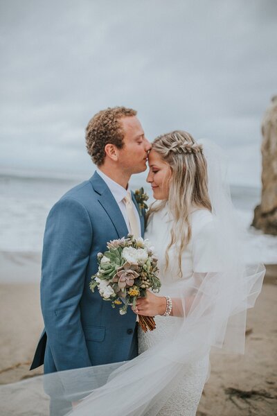 Sacramento Wedding Photographers capture bride and groom kissing on beach