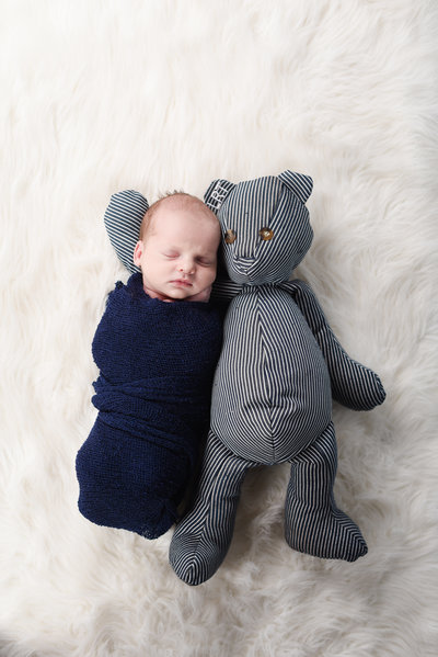 Beautiful Mississippi Newborn Photography:newborn boy wrapped in navy with teddy bear made from grandfather's overalls
