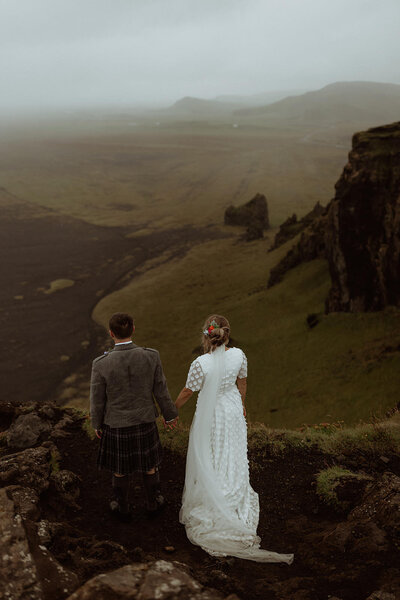 Bride and groom overlook Icelandic landscpare
