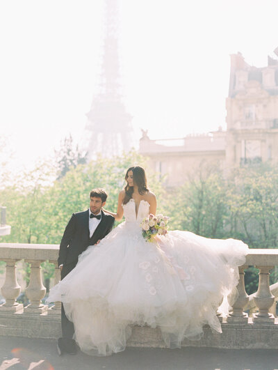 Bride and groom at Eiffel Tower for intimate destination wedding in Paris, France