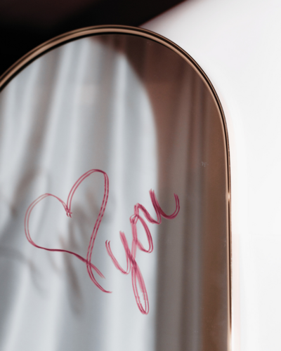 oval mirror with love you in lipstick a reflection on love