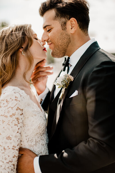 husband and wife kissing on wedding day