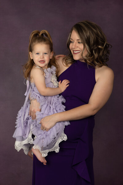 mom-and-toddler-in-studio-arlington-posing-in-purple-dresses