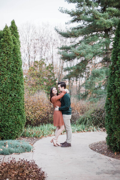 couple posing on a sidewalk at Knoxville Botanical Gardens engagement session
