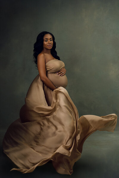 maternity photoshoot with gold flowing fabric