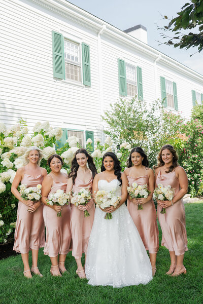 Bride standing with bridesmaids, Unique Melody Events & Design helped with wedding planning
