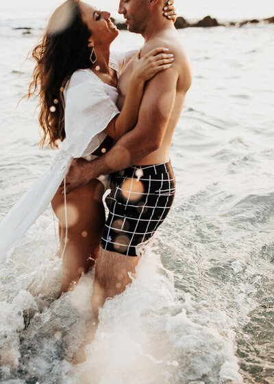 couple holding each other at beach