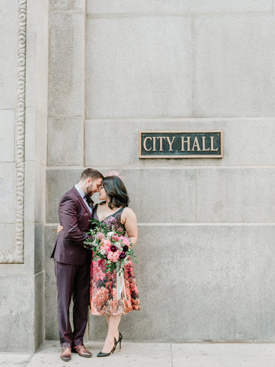 couple standing in front of city hall