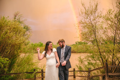bride and groom dance under a rainbow at Hyatt Regency Tamaya
