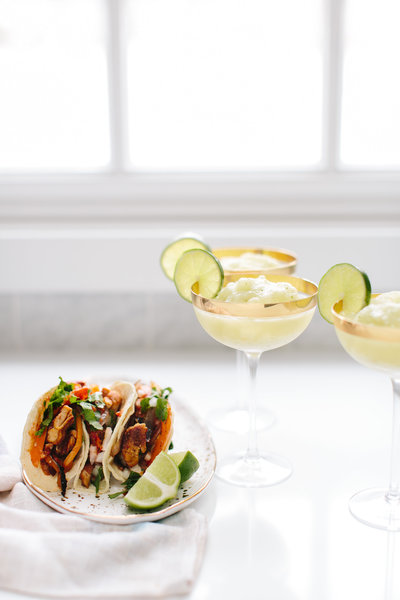 tacos and margaritas on a table