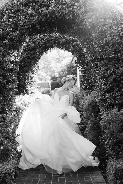 bride  plays with her gown at Boxwood Manor in Houston Texas by Swish and Click Photography