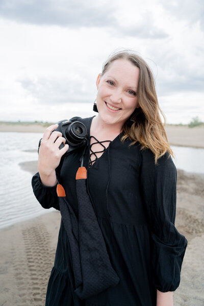 Seattle Wedding Photographer captures woman holding camera and smiling