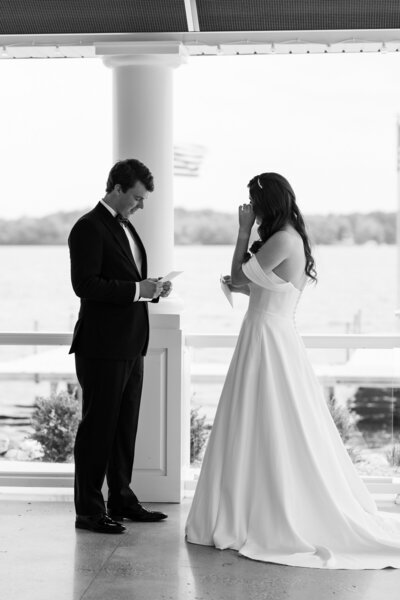 intimate moments between bride and groom during their first look on Gun Lake at Bay Pointe Inn