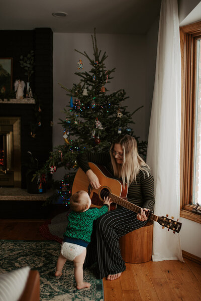 woman playing guitar with baby