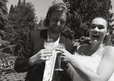 bride and groom smiling at table in Van Dusen Gardens