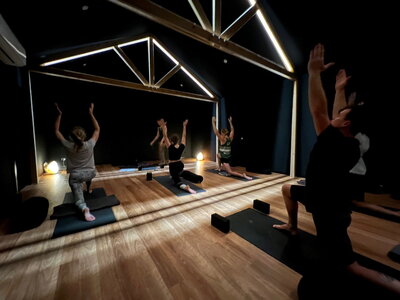 people doing yoga in dark yoga studio