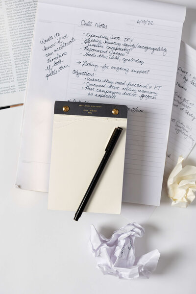 Black and white photo of Chessica LaBianca's hands writing on a notepad