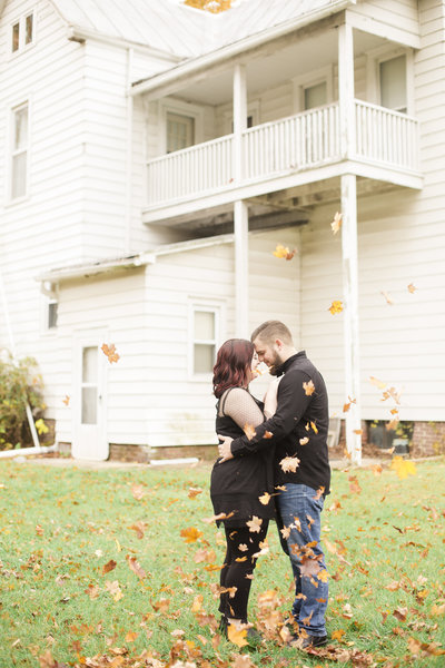 Couple portrait with fall leaves