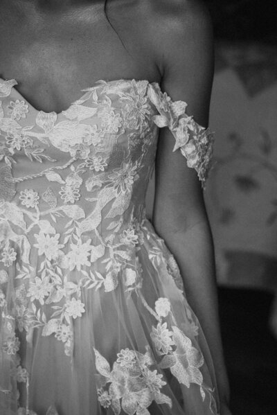Floral-lace-details-on-bride's-off-the-shoulder-wedding-dress