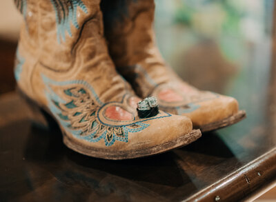 wedding rings sitting on boots