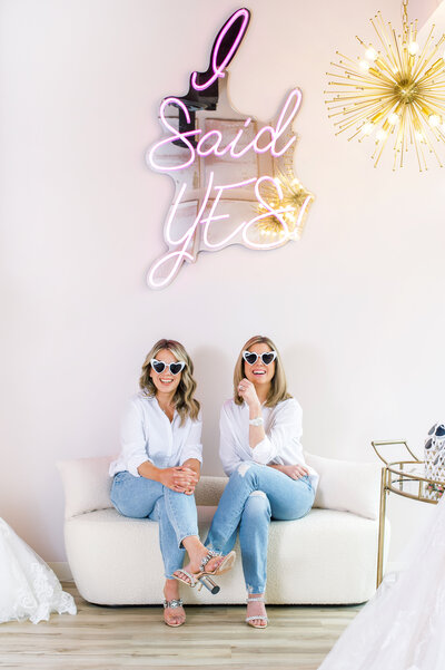 Boutique Owners Katie & Tina under I Said Yes sign - Bride to Be Boutique