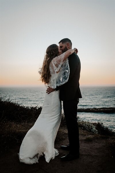 Eloping Couple Kissing At Sunset