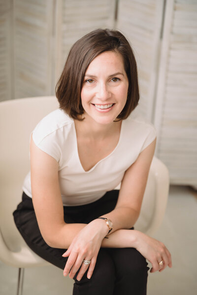 Sarah Weisbrod, Flutist & Teaching Artist, Sitting in a White Chair