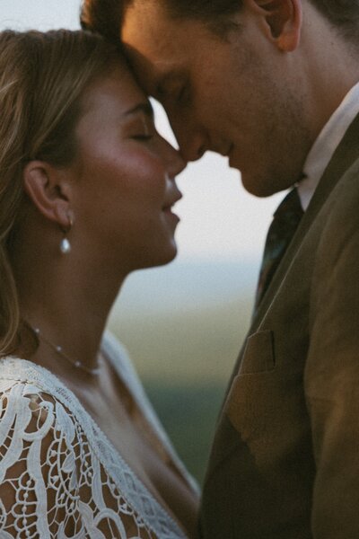 An intimate moment between a young couple celebrating their elopement in the north georgia mountains.