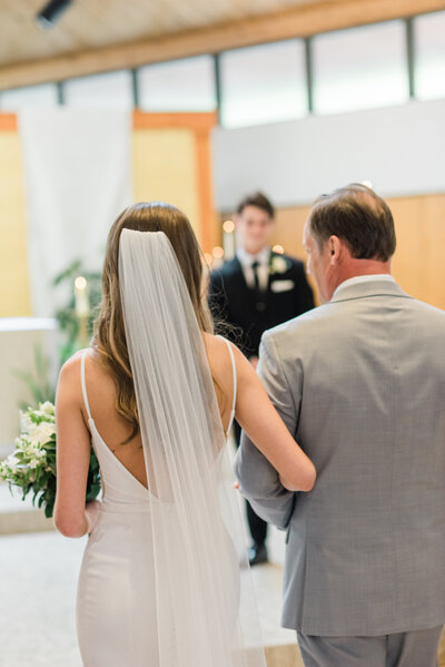 Father walking daughter down the aisle