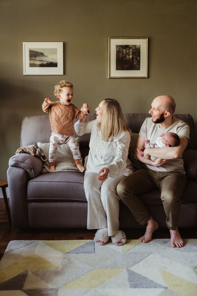 family photo on sofa jumping
