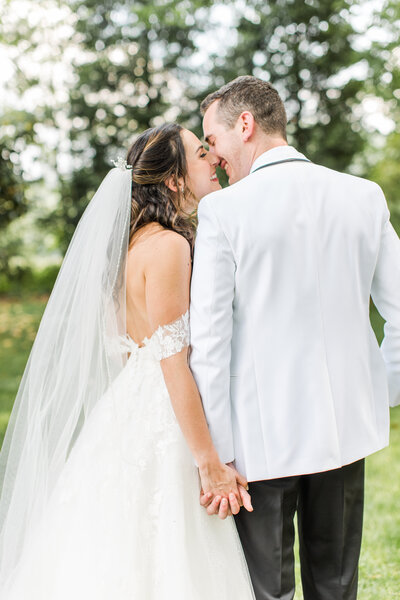husband and wife kiss on wedding day