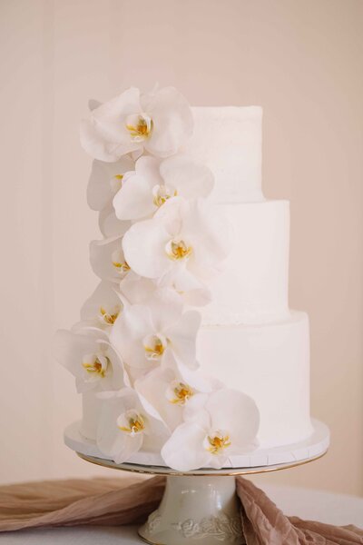 Orchids Cascading Down  White Wedding Cake - Mikayla & Mario | Harmony Meadows Wedding - Lake Chelan Wedding
