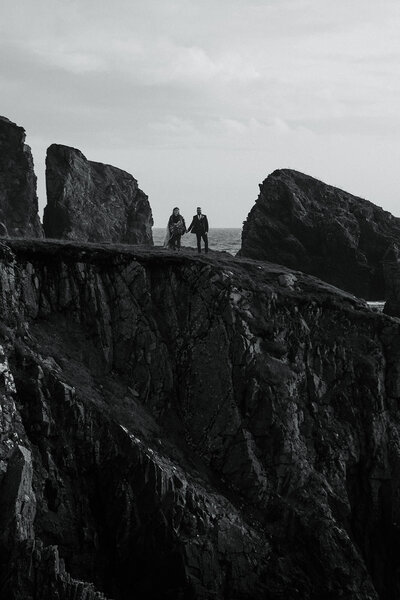 Couple stand on cliffs